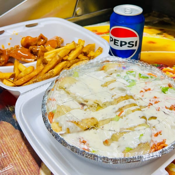 Carytown Gyro's chicken over rice with white sauce, a side of fries, buffalo wings, and a Pepsi.